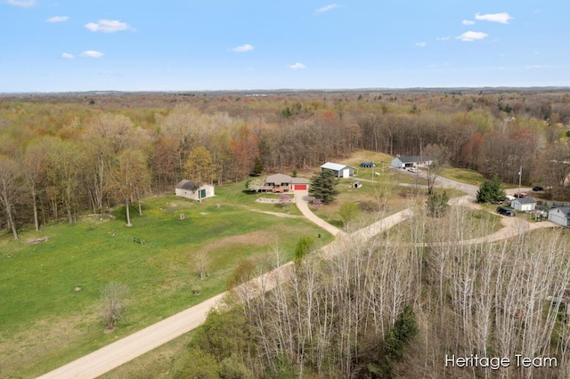 drone / aerial view with a wooded view