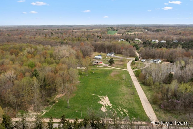 drone / aerial view with a wooded view