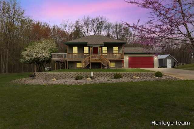 view of front of home featuring stairway, a lawn, an attached garage, and concrete driveway