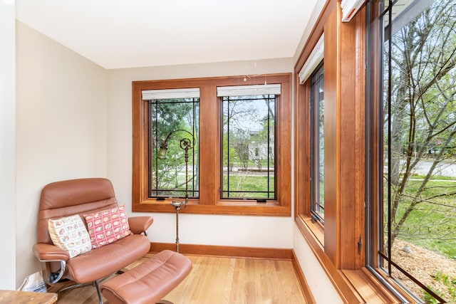 sitting room featuring baseboards and light wood-type flooring