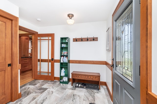 entryway with baseboards and french doors