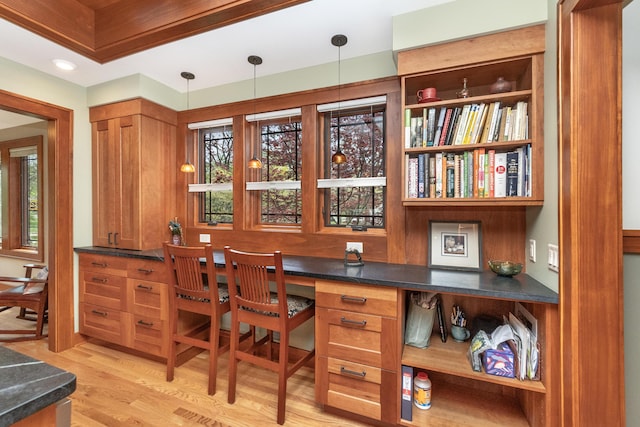 interior space with pendant lighting and light wood-style floors