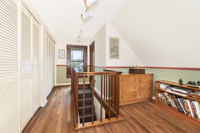 additional living space with baseboards and wood-type flooring
