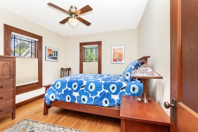 bedroom featuring baseboards, ceiling fan, and wood finished floors