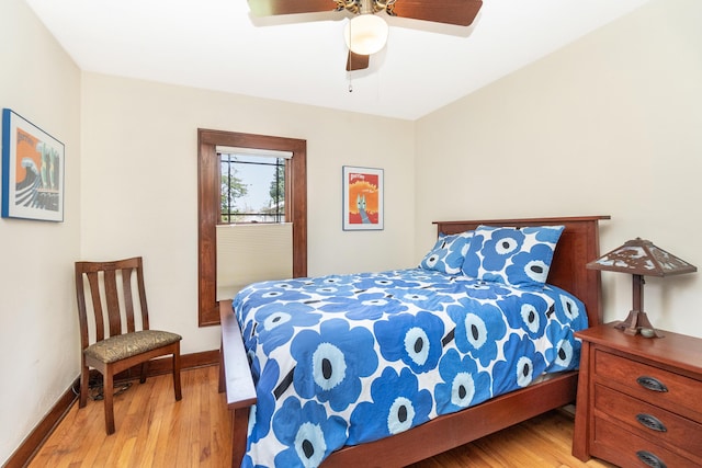 bedroom with baseboards, a ceiling fan, and light wood-style flooring