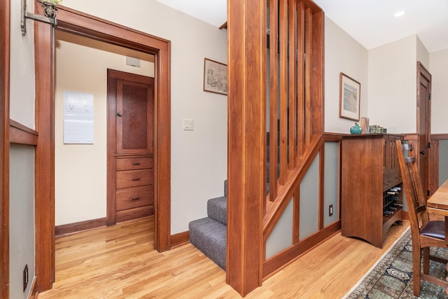 staircase with baseboards and wood finished floors