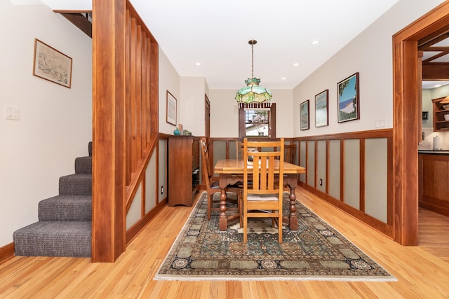 dining room featuring recessed lighting, wood finished floors, and stairway