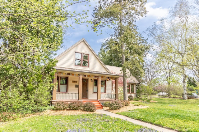 bungalow-style house with covered porch and a front yard