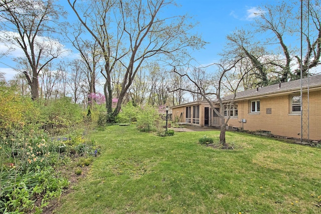 view of yard featuring a sunroom