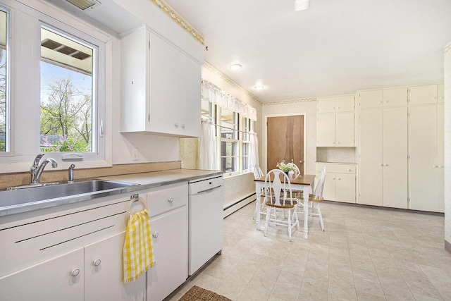 kitchen with white dishwasher, a sink, a baseboard radiator, and a wealth of natural light