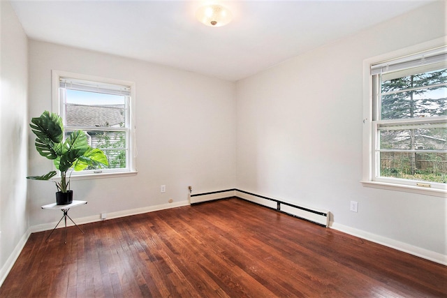 empty room featuring wood-type flooring and baseboards
