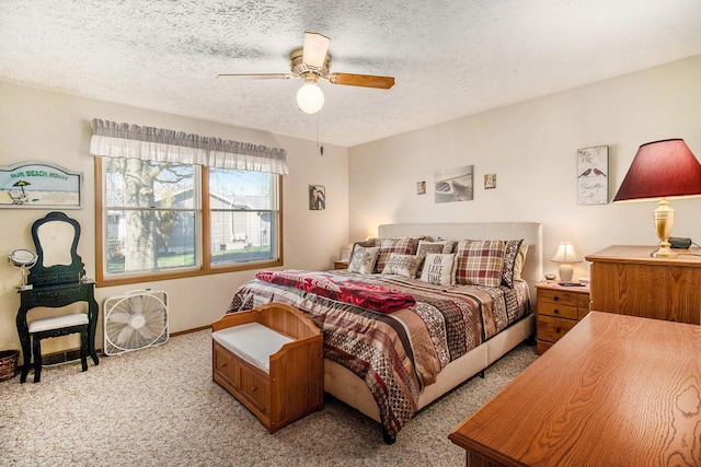 bedroom with light colored carpet, a ceiling fan, a textured ceiling, and baseboards
