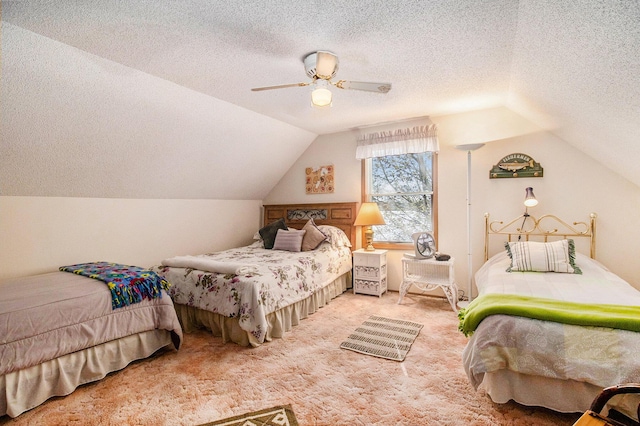 bedroom with carpet flooring, a textured ceiling, vaulted ceiling, and ceiling fan