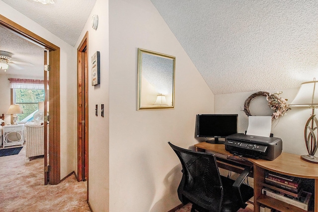 carpeted home office with a ceiling fan, a textured ceiling, and lofted ceiling