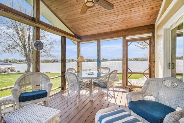sunroom featuring outdoor dining space, a water view, and ceiling fan