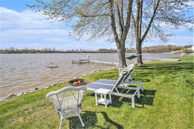 dock area featuring a water view and a yard