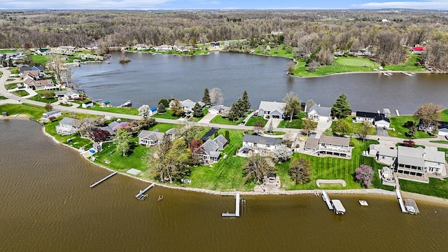 aerial view featuring a water view, a residential view, and a wooded view