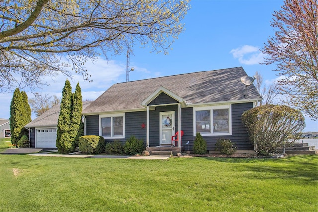 view of front of house with a garage, a shingled roof, and a front lawn