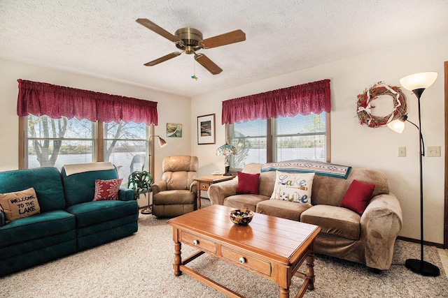 carpeted living room featuring a textured ceiling, plenty of natural light, and ceiling fan