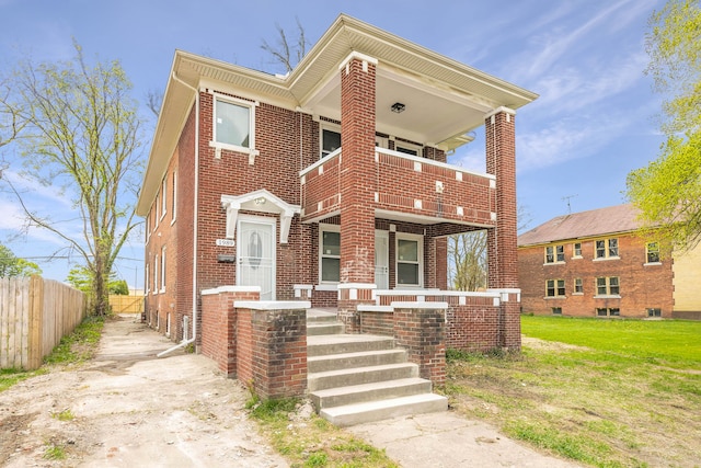 1989 Gladstone St, Detroit, MI 48206 - view of front of home featuring a porch, brick siding, fence, a balcony, and a front lawn