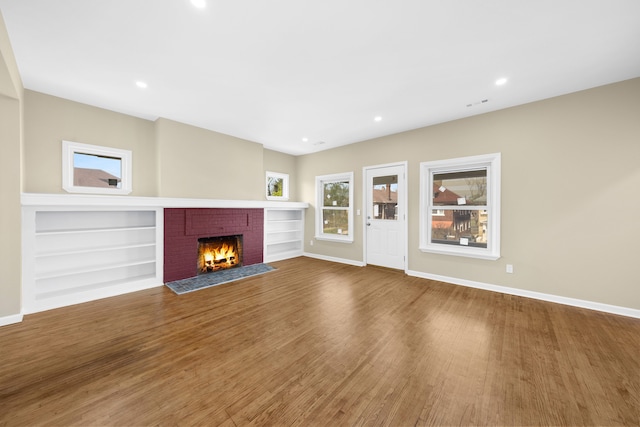 1989 Gladstone St, Detroit, MI 48206 - unfurnished living room featuring built in features, baseboards, a fireplace, and wood finished floors