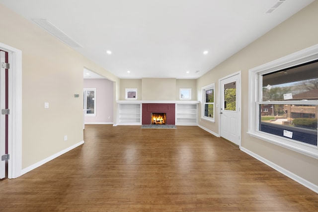 1989 Gladstone St, Detroit, MI 48206 - unfurnished living room with baseboards, recessed lighting, wood finished floors, and a fireplace