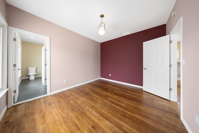 1989 Gladstone St, Detroit, MI 48206 - unfurnished bedroom with baseboards, wood finished floors, and visible vents