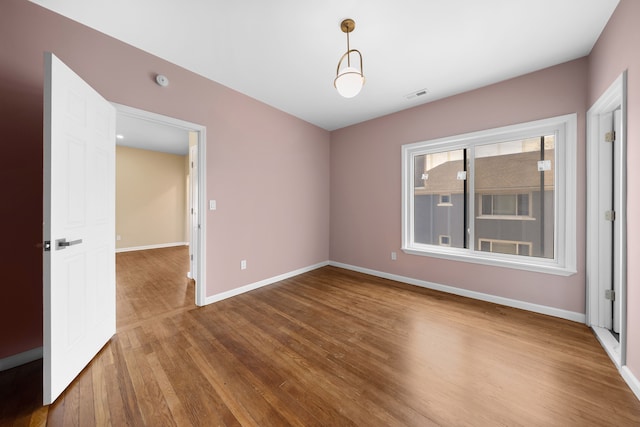 1989 Gladstone St, Detroit, MI 48206 - spare room featuring visible vents, baseboards, and wood finished floors