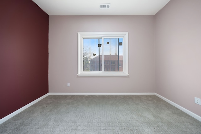 1989 Gladstone St, Detroit, MI 48206 - spare room featuring baseboards, visible vents, and carpet