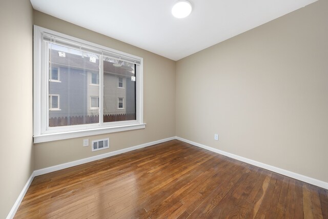 1989 Gladstone St, Detroit, MI 48206 - spare room featuring baseboards, visible vents, and hardwood / wood-style floors