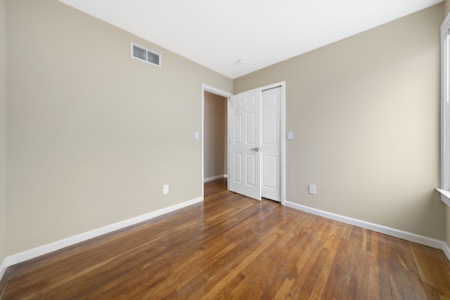 1989 Gladstone St, Detroit, MI 48206 - unfurnished bedroom with baseboards, hardwood / wood-style floors, and visible vents