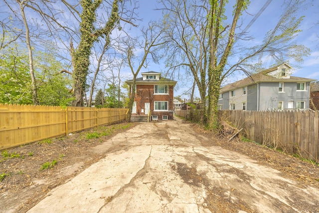 1989 Gladstone St, Detroit, MI 48206 - back of property with brick siding and a fenced backyard