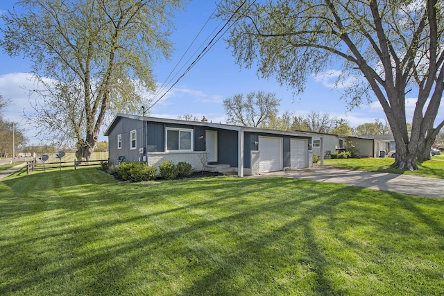 single story home featuring an attached garage, fence, a front yard, and concrete driveway