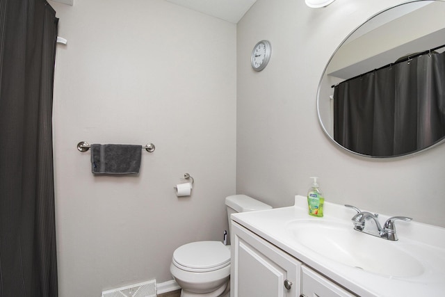 bathroom featuring toilet, visible vents, and vanity