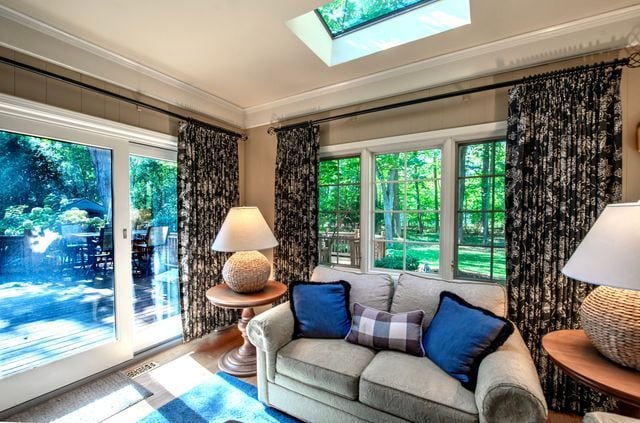 living area featuring a skylight, ornamental molding, and plenty of natural light