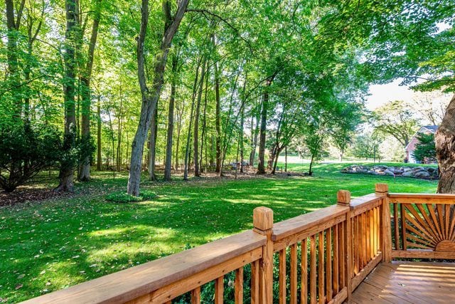 surrounding community featuring a yard and a wooden deck