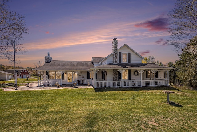 3121 Grace Rd, Frankfort, MI 49635 - back of property with covered porch, a chimney, and a yard