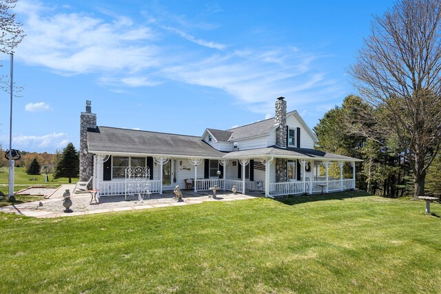3121 Grace Rd, Frankfort, MI 49635 - back of property featuring a chimney, a porch, and a yard