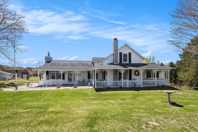 3121 Grace Rd, Frankfort, MI 49635 - view of front of property featuring covered porch, a chimney, and a front lawn