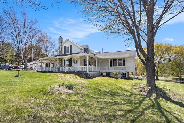 3121 Grace Rd, Frankfort, MI 49635 - country-style home with covered porch, a chimney, and a front lawn