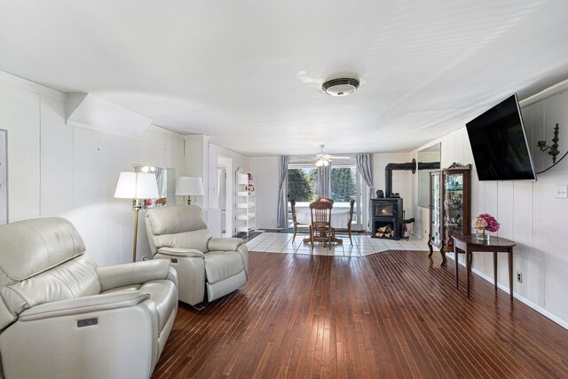 3121 Grace Rd, Frankfort, MI 49635 - living room featuring a wood stove, wood-type flooring, and ceiling fan