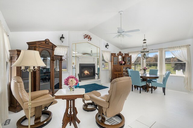 3121 Grace Rd, Frankfort, MI 49635 - living area with vaulted ceiling, ceiling fan, and a glass covered fireplace
