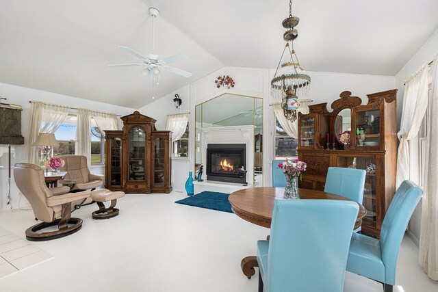 3121 Grace Rd, Frankfort, MI 49635 - living area with vaulted ceiling, a ceiling fan, and a glass covered fireplace