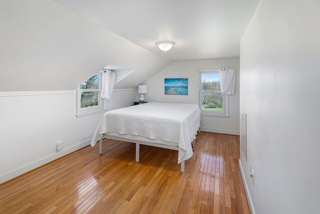 3121 Grace Rd, Frankfort, MI 49635 - bedroom with light wood-style floors, baseboards, and lofted ceiling