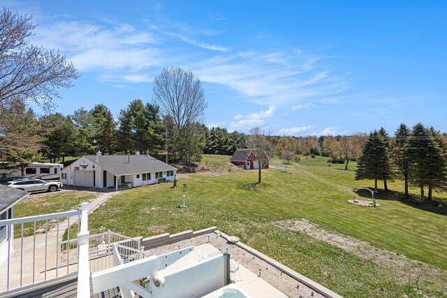 3121 Grace Rd, Frankfort, MI 49635 - view of green lawn featuring a garage, driveway, and an outdoor structure