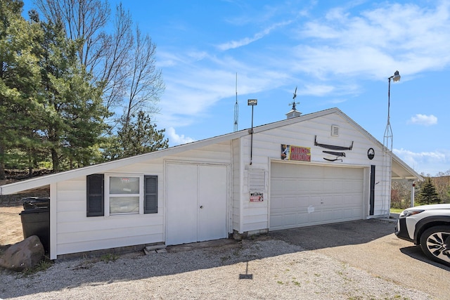 3121 Grace Rd, Frankfort, MI 49635 - view of front of house featuring a detached garage and an outbuilding