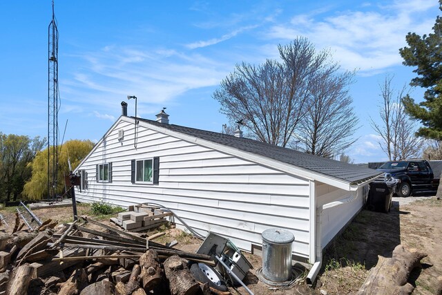 3121 Grace Rd, Frankfort, MI 49635 - view of side of home with a chimney