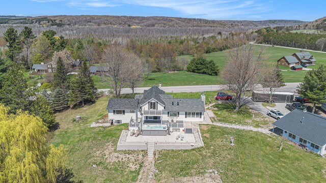 3121 Grace Rd, Frankfort, MI 49635 - aerial view of property and surrounding area featuring a heavily wooded area