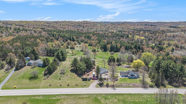 3121 Grace Rd, Frankfort, MI 49635 - aerial view of property and surrounding area featuring a heavily wooded area