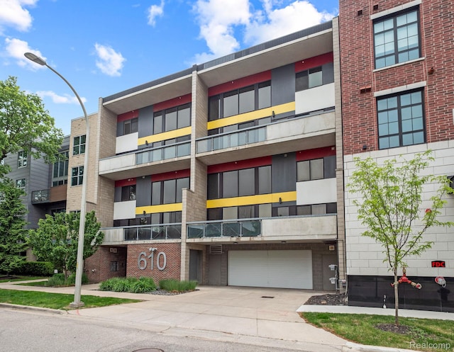 610 S Troy St, Royal Oak, MI 48067 - view of apartment building / complex featuring driveway and an attached garage